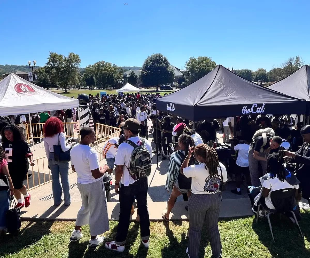 Students gathering around haircut stations at a theCut Campus Swarm at Alabama A&M